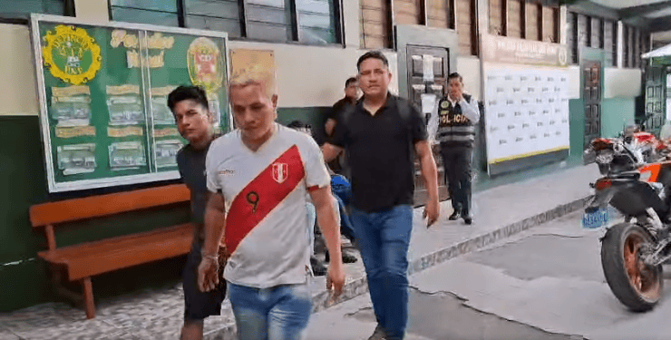 Hombres siendo escoltados por policías en la calle de Loreto, Perú, tras un incidente en la zona.