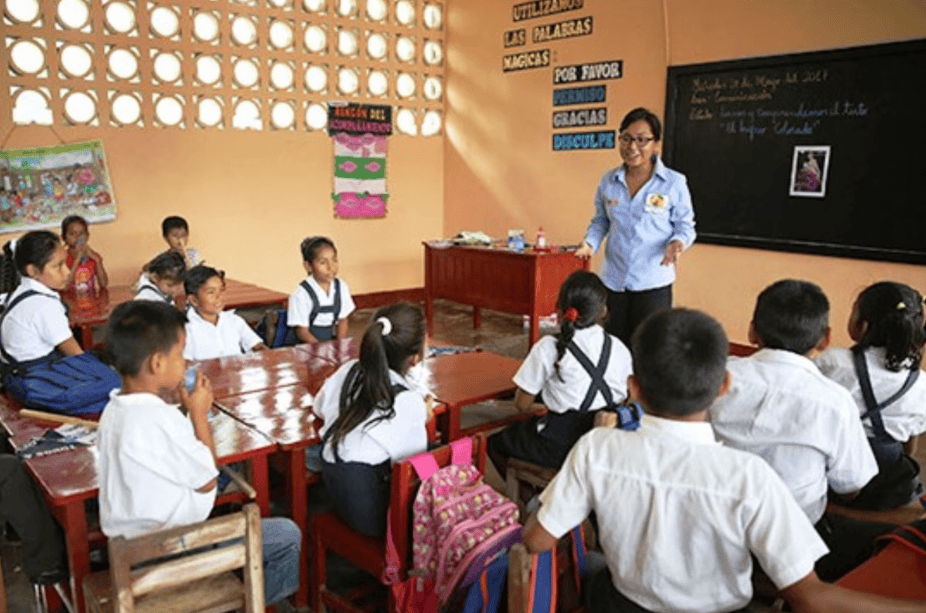 Docente enseñando a estudiantes en aula de escuela primaria Loreto Noticias en Perú, educación infantil en Loreto, clases escolares en zona rural de Loreto, enseñanza para niños en clase de escuela peruana.