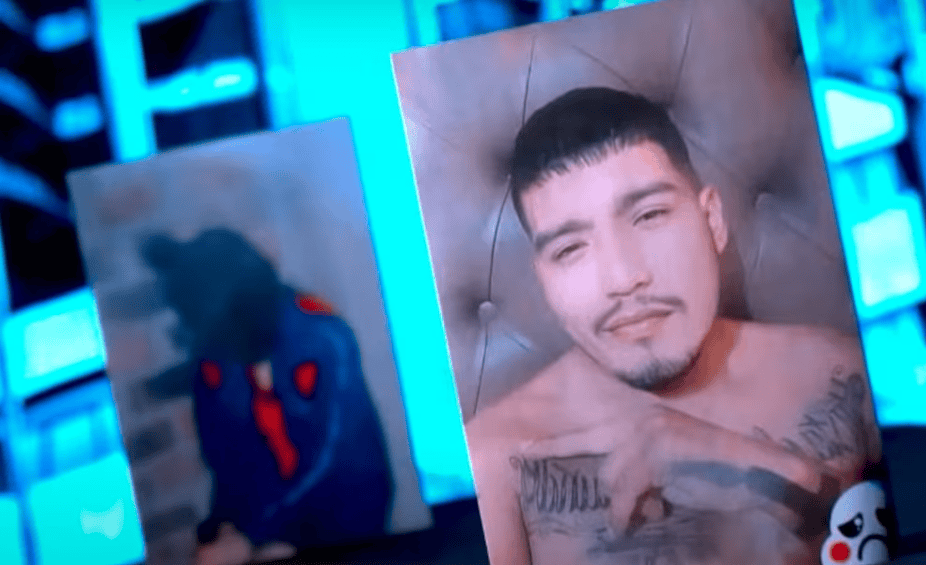 Hombre con tatuajes en el pecho y rostro relajado, en un entorno con iluminación azul y pantallas digitales, en un contexto posiblemente de medios o noticias en Loreto.