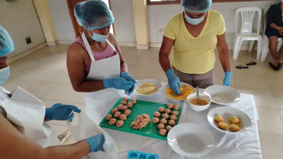 Elaboración de alimentos tradicionales en Loreto, Perú, con técnicas de cocina comunitaria y participación de chefs locales, promoviendo la cultura y gastronomía regional.
